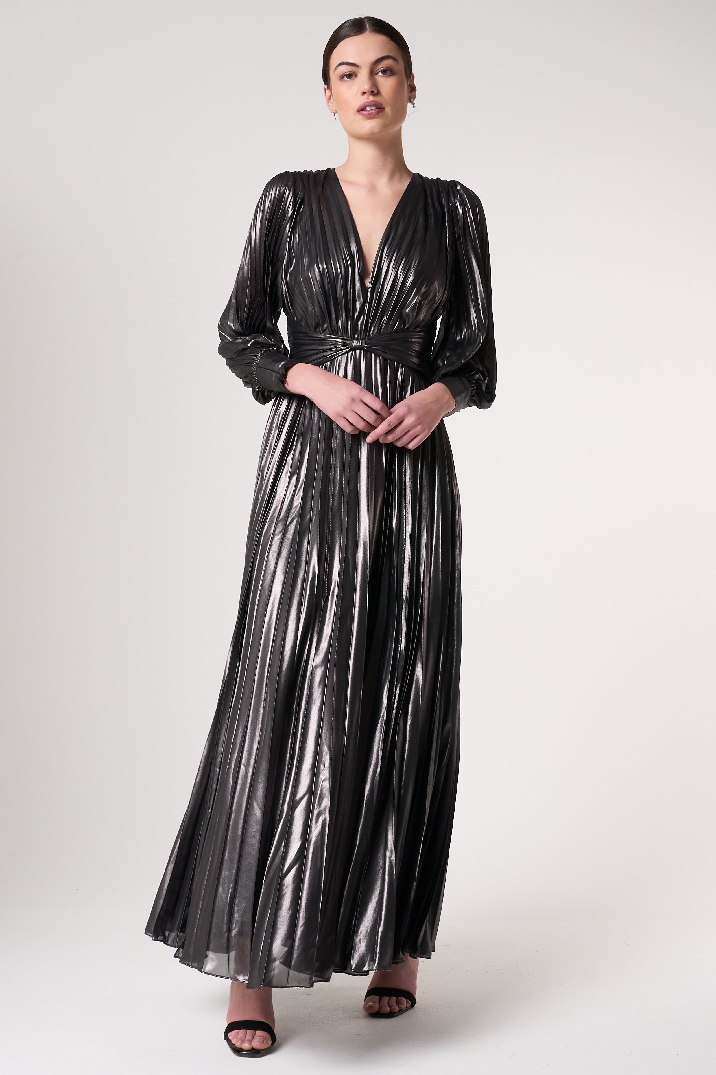 Alberta metallic charcoal pleated maxi dress with V neckline, blouson sleeves and waist twist detail designed for elegant evening and occasion wear styling