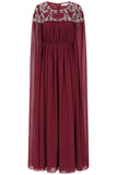 Frock & Frill Aruna burgundy embellished cape maxi dress with sparkling beaded bodice, flowing chiffon cape sleeves, and elegant full-length silhouette—ideal for weddings and formal events.