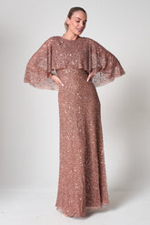 Charlotte rose gold sequin maxi dress with elegant cape overlay, round neckline, and flowing floor-length silhouette