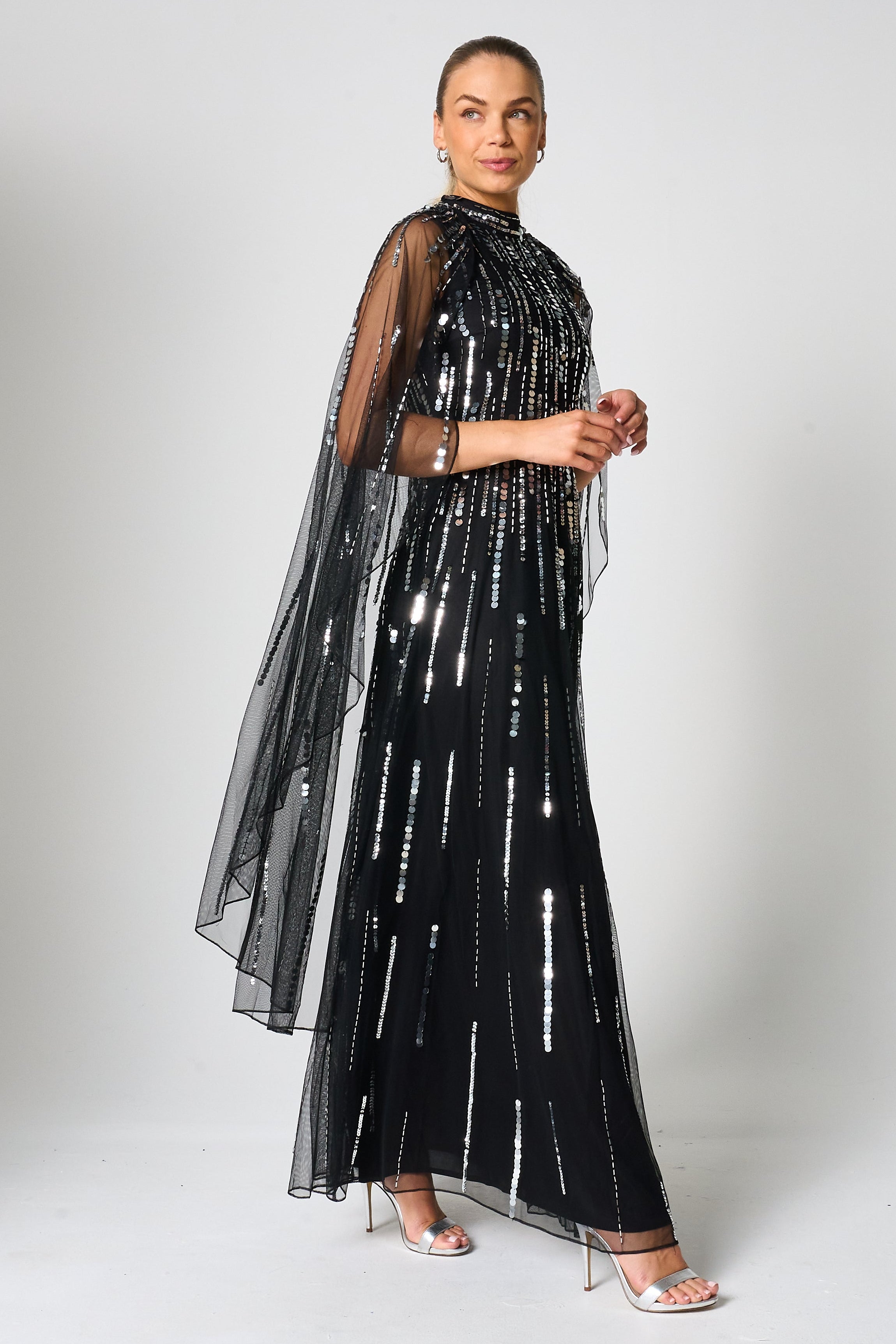 Eileen black sequin cape sleeve maxi dress with full-length silhouette and all-over sparkle designed for elegant evening and occasion wear styling