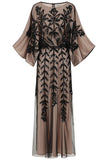 Elva sequin maxi dress with black leaf motif embellishment on a neutral base, batwing sleeves and flowing silhouette for statement occasion wear styling