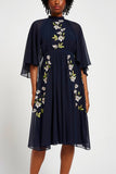 Maeve navy floral embroidered midi dress by Frock and Frill with high neckline, flowing cape sleeves, and elegant silhouette.