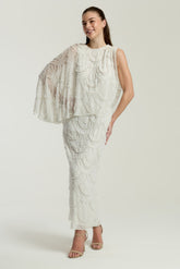 Neva White Embellished Asymmetric Cape Sleeve Maxi Dress – midaxi-length wedding or formal evening gown with flowing cape overlay and delicate embellishments