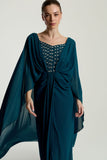 Rhea teal cape sleeve maxi dress with silver-embellished bodice, flowing cape overlay, and modest elegant silhouette for weddings and formal events.