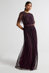 Talia dark purple embellished maxi dress with long sleeves, beaded bodice, and flowing skirt, suitable for bridesmaids or formal occasions.