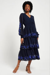Frock & Frill Tamsin navy floral embroidered midi dress with tiered chiffon skirt, sheer long sleeves, and vibrant blue embroidered detailing—perfect for weddings and special occasions.