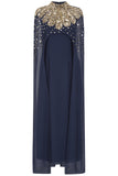 Zadie Navy Embellished Cape Maxi Dress with gold embellished neckline and flowing sheer cape