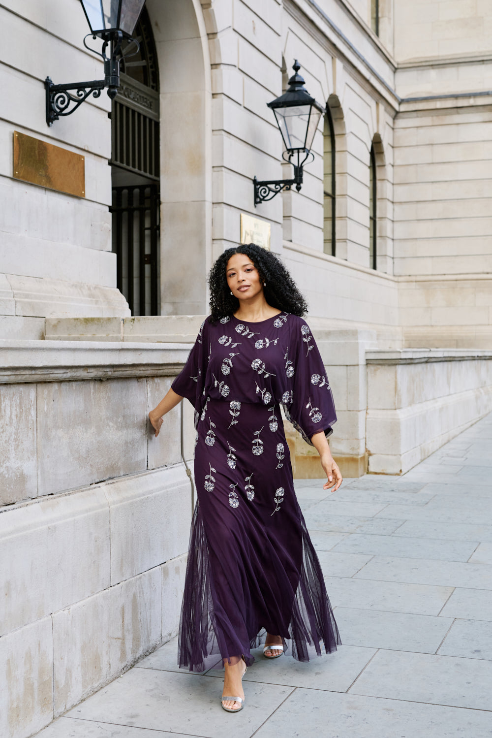 Naida dark purple embellished maxi dress with long sleeves, floral bead details, and floor-length flowing silhouette, suitable for weddings and formal occasions.