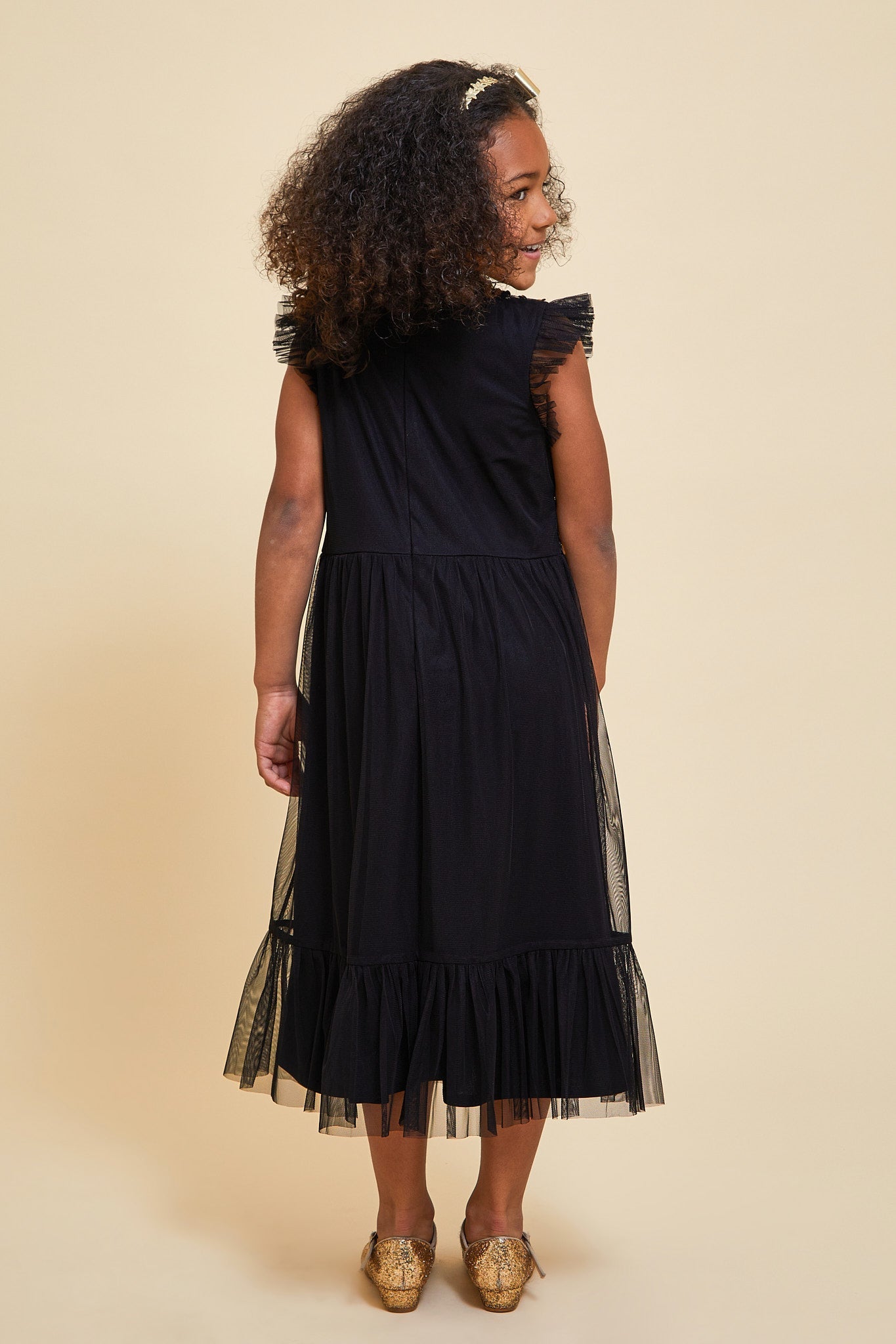 Stella black and gold sequin dress with reversible sequin bodice and ruffle detailing designed for party wear and special occasion styling