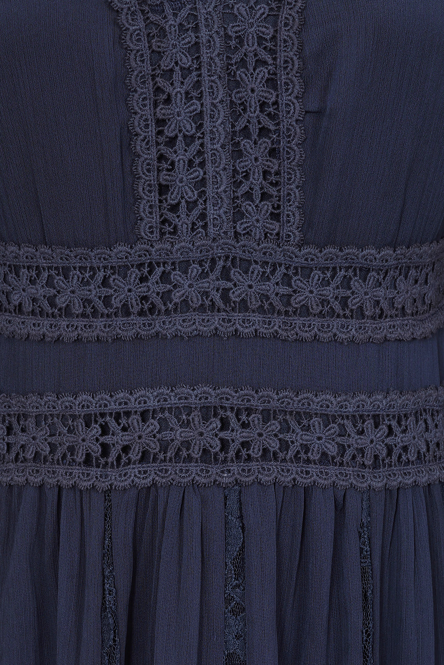 Frock & Frill Aiden navy chiffon maxi dress with sheer long sleeves, lace detailing, and a flowing elegant silhouette—perfect for weddings, evening events, and formal occasions.