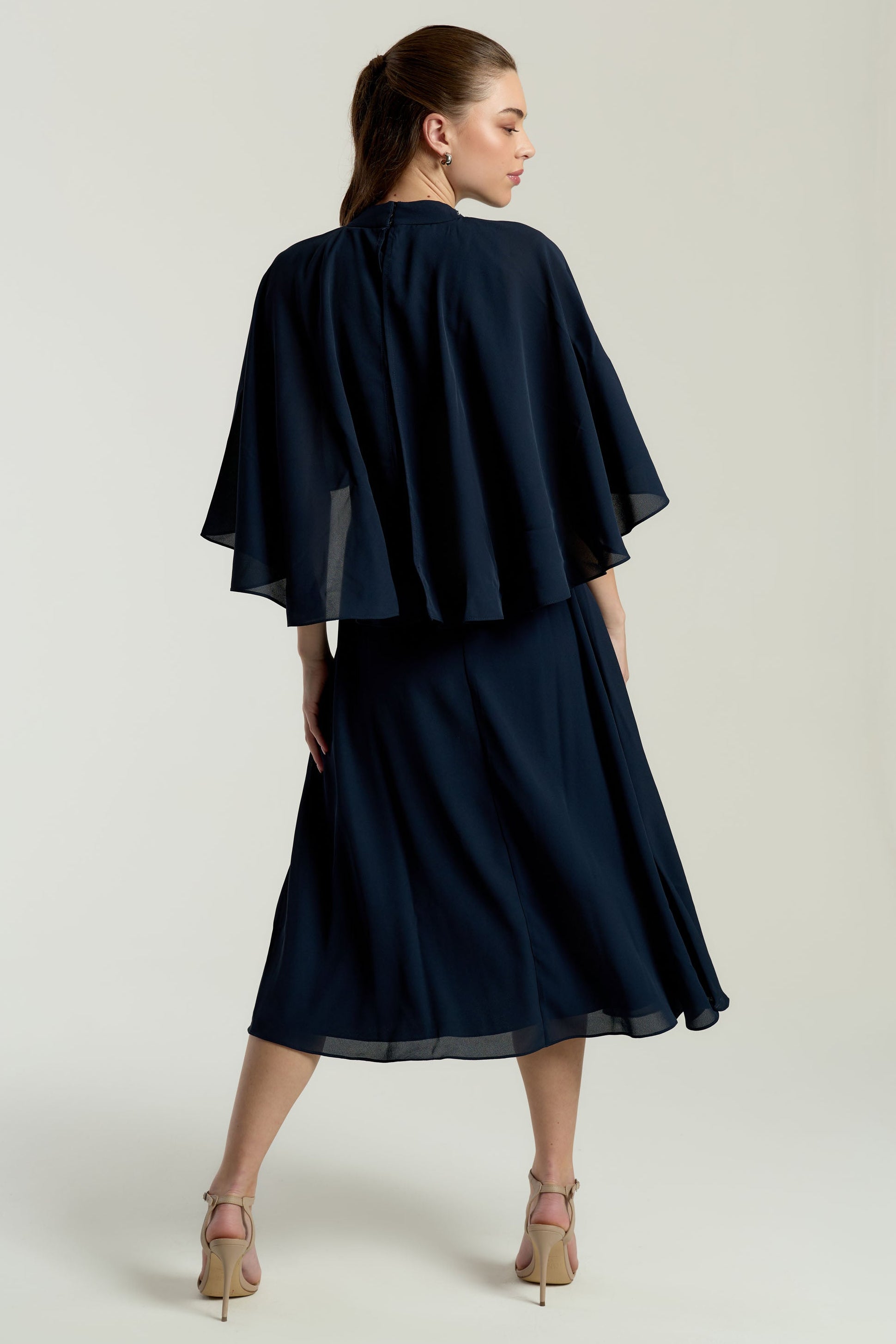 Alani navy embellished cape sleeve midi dress by Frock and Frill with high neckline, silver embellishment and flowing cape sleeves designed for elegant occasion wear styling