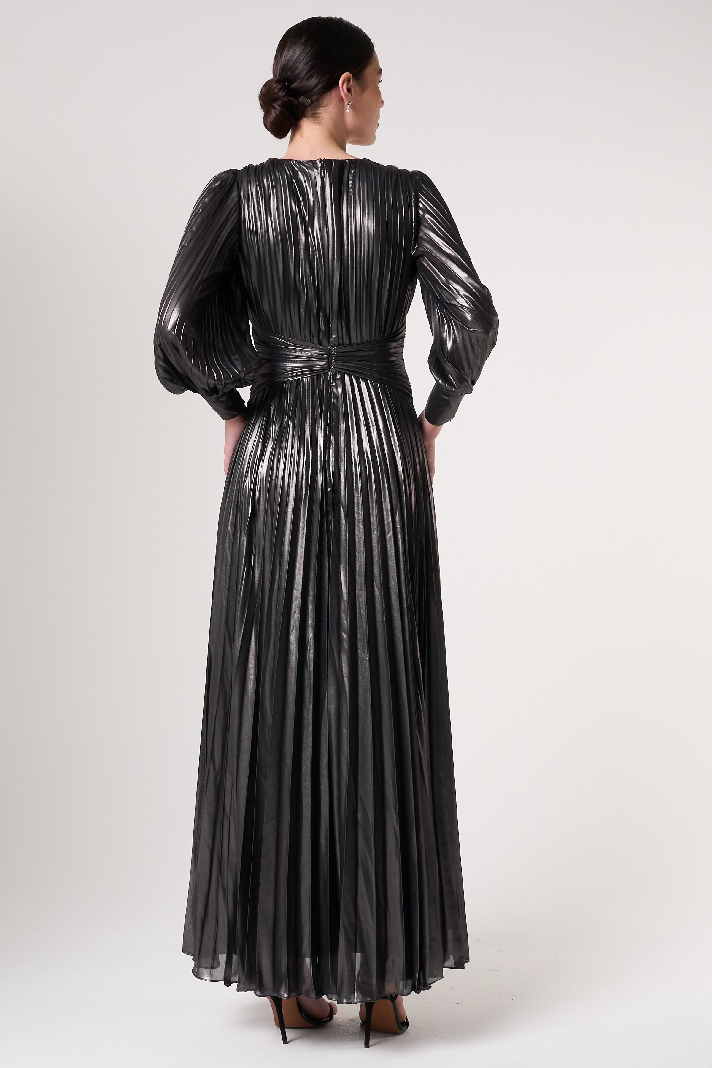 Alberta metallic charcoal pleated maxi dress with V neckline, blouson sleeves and waist twist detail designed for elegant evening and occasion wear styling