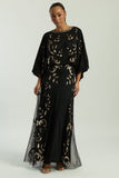 Black maxi dress with gold sequin floral embellishment, flowing sheer sleeves and full-length silhouette, Ambretta by Frock and Frill.