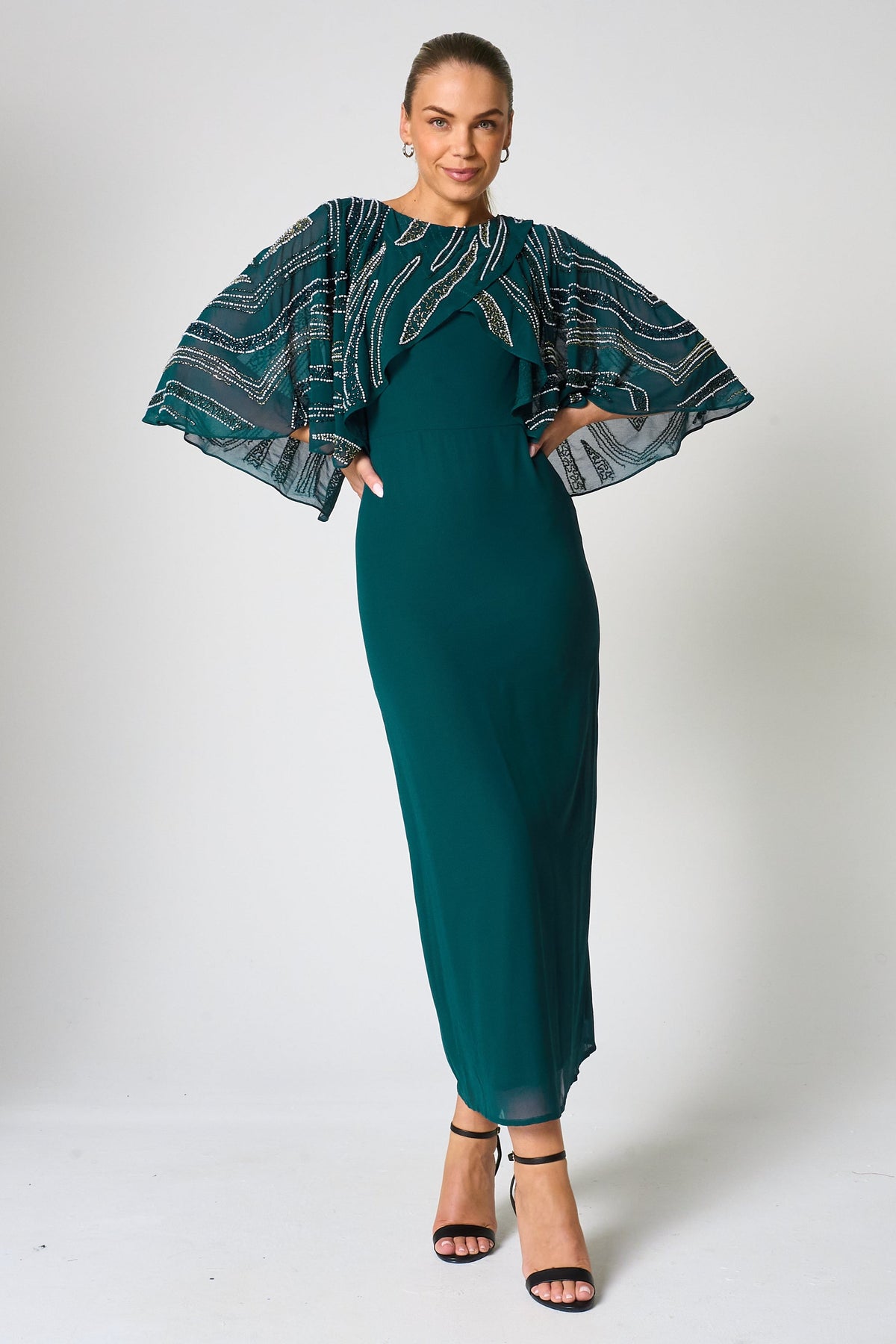 Anna storm green embellished midaxi dress with cape overlay and beadwork detailing designed for elegant wedding guest and occasion wear styling