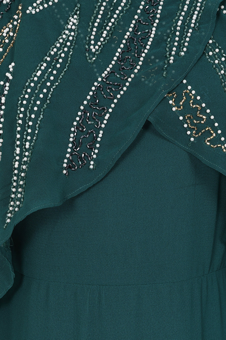 Anna storm green embellished midaxi dress with cape overlay and beadwork detailing designed for elegant wedding guest and occasion wear styling