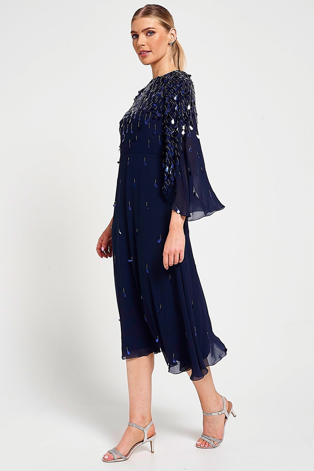 Annette navy embellished cape sleeve midi dress with tonal sequin detailing and flowing silhouette designed for elegant wedding guest and occasion wear styling