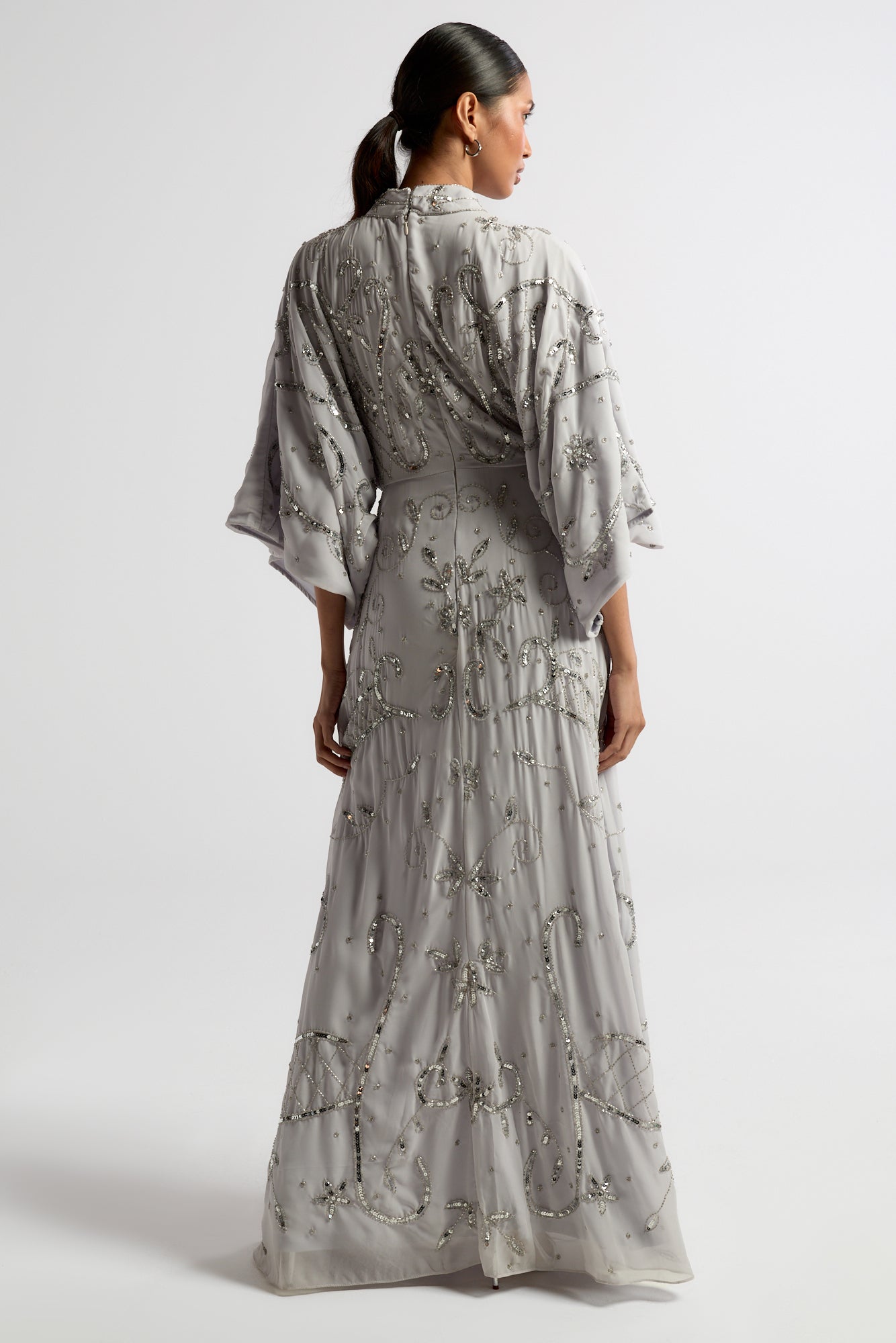 Aramina Silver Embellished Maxi Dress with long sleeves, floor-length silhouette, beaded and sequined detailing, modest evening gown for weddings and formal events.