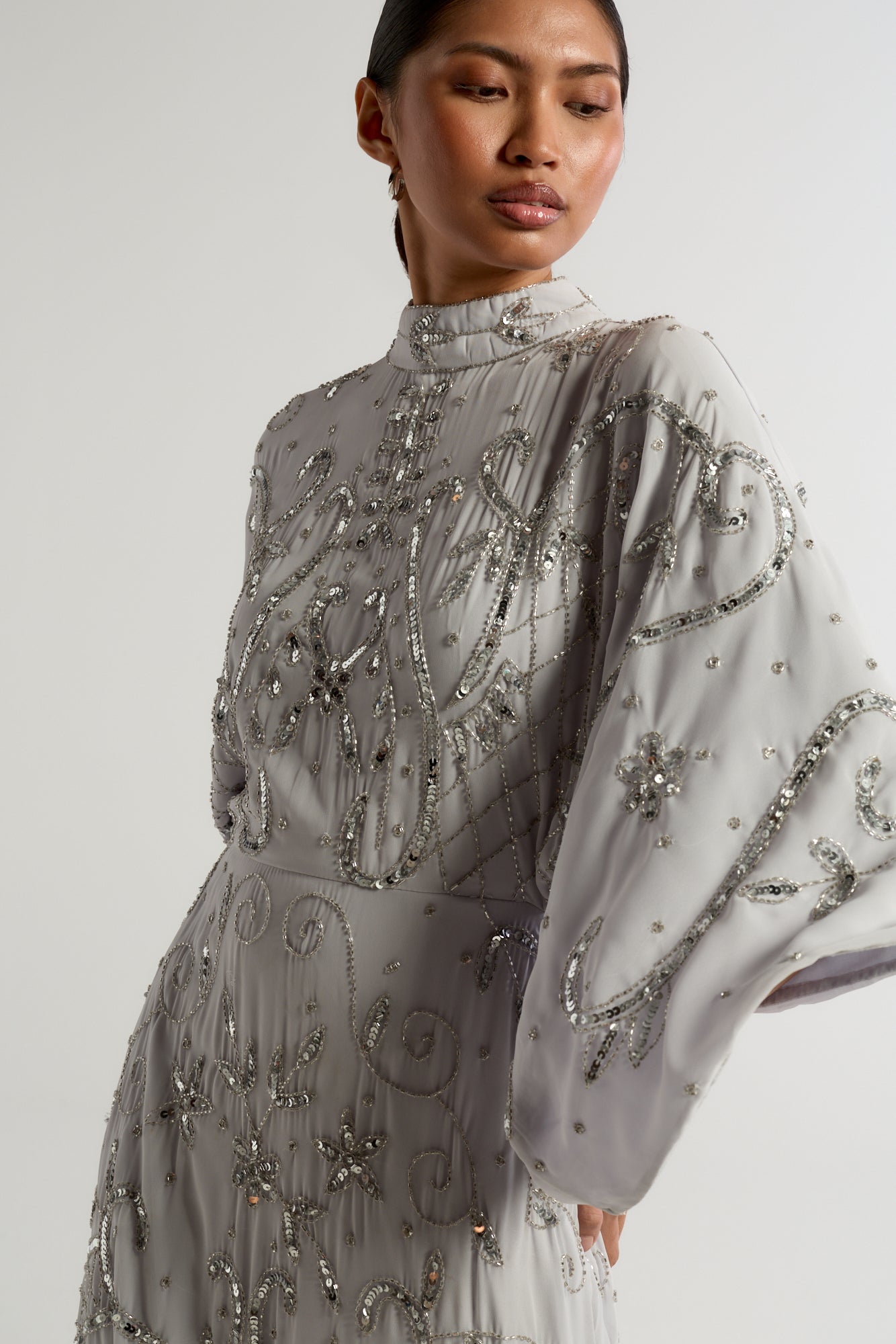 Aramina Silver Embellished Maxi Dress with long sleeves, floor-length silhouette, beaded and sequined detailing, modest evening gown for weddings and formal events.