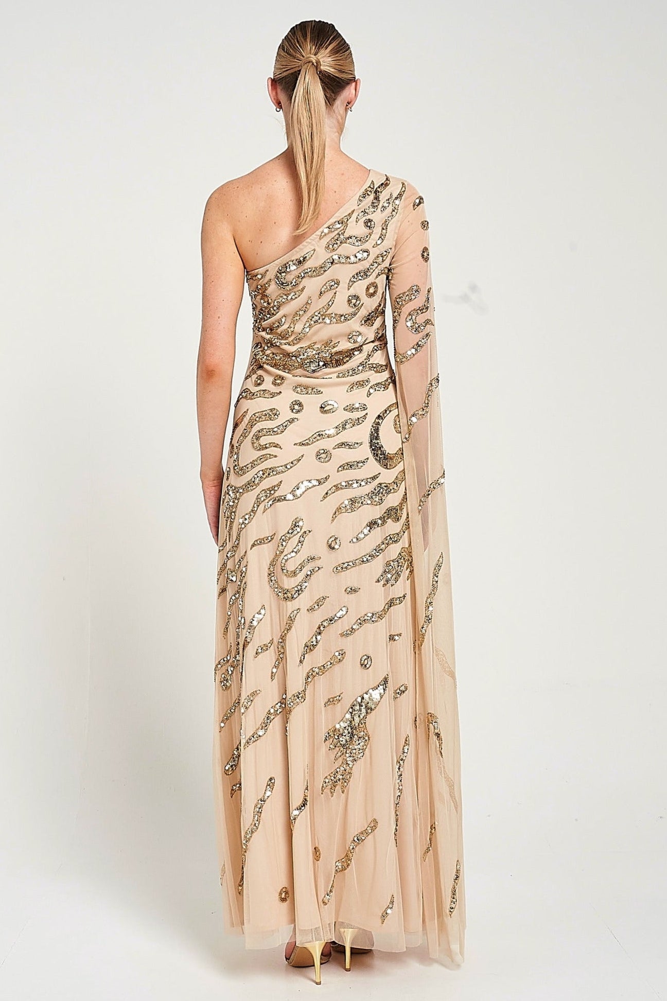 Arlene one shoulder cape sleeve embellished maxi dress in nude gold with sequin detailing designed for elegant evening and occasion wear styling