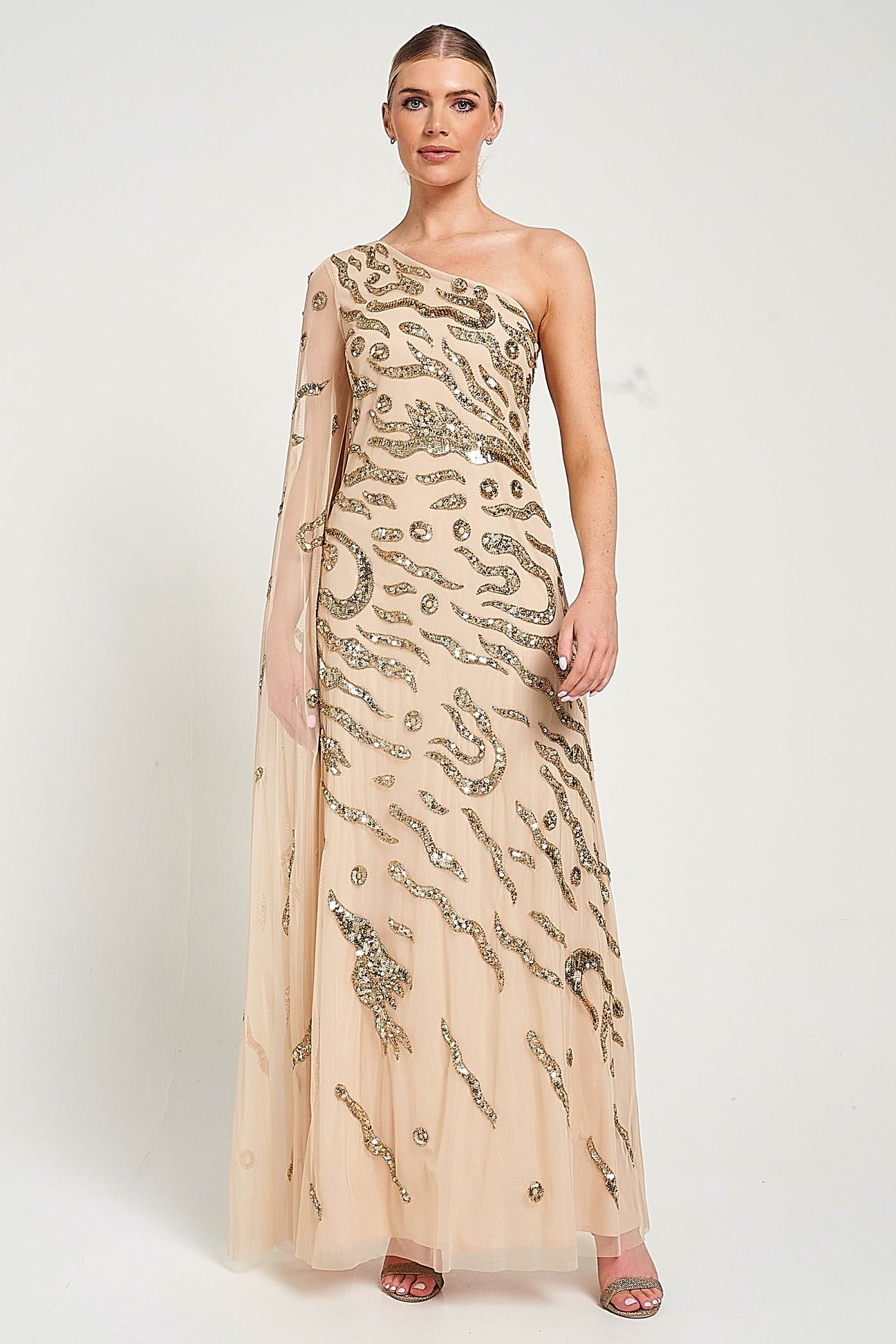 Arlene one shoulder cape sleeve embellished maxi dress in nude gold with sequin detailing designed for elegant evening and occasion wear styling