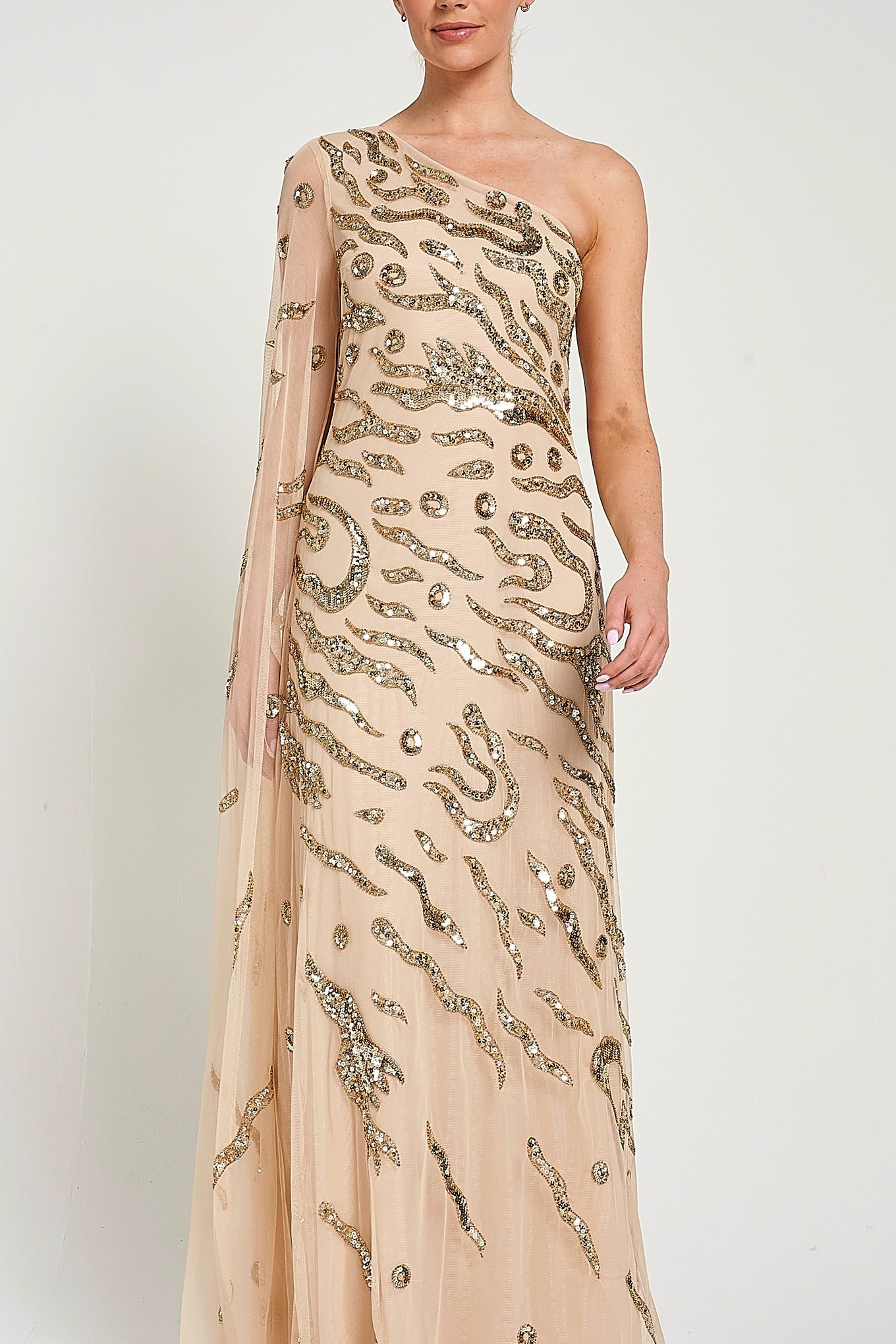 Arlene one shoulder cape sleeve embellished maxi dress in nude gold with sequin detailing designed for elegant evening and occasion wear styling