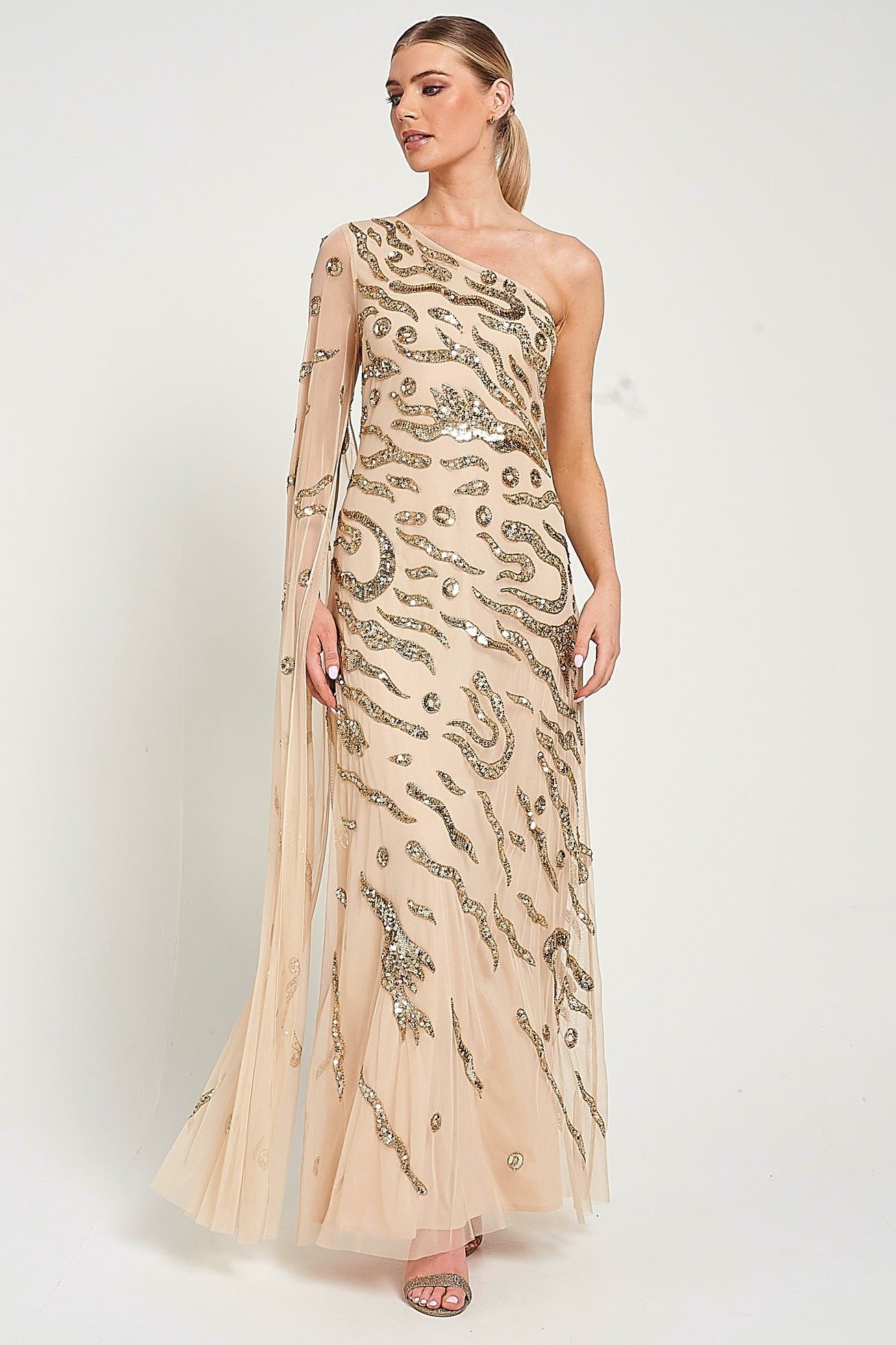 Arlene one shoulder cape sleeve embellished maxi dress in nude gold with sequin detailing designed for elegant evening and occasion wear styling