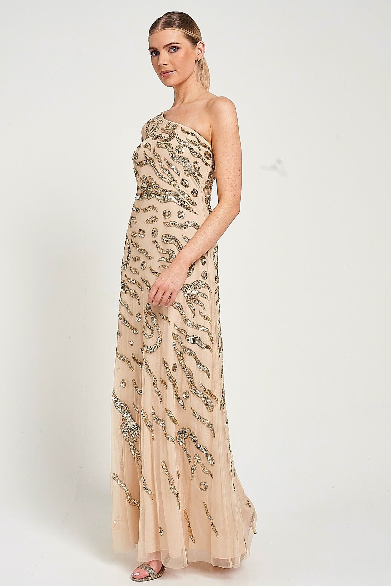 Arlene one shoulder cape sleeve embellished maxi dress in nude gold with sequin detailing designed for elegant evening and occasion wear styling