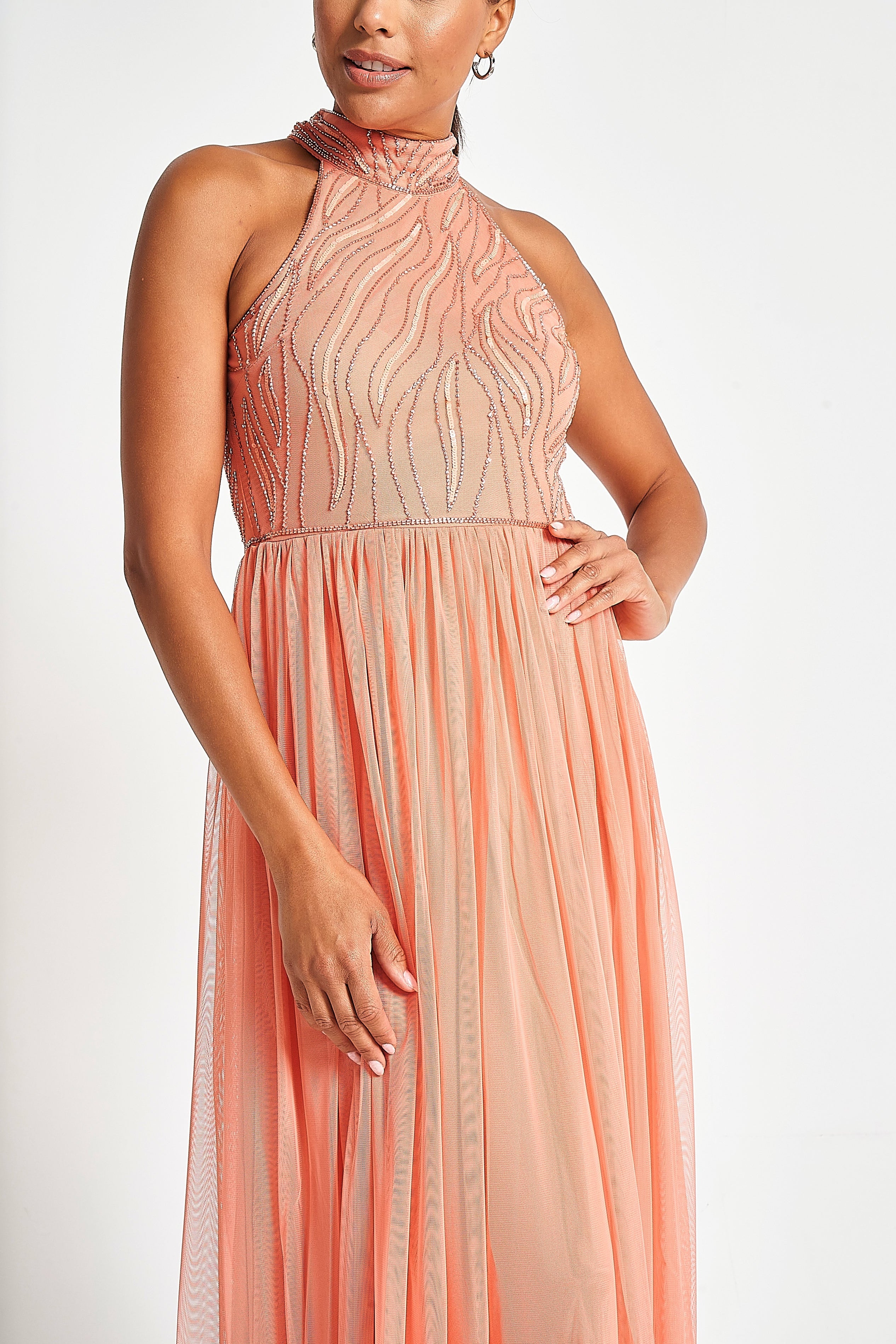 Caroline coral embellished halter neck maxi dress with intricate bead detailing and flowing full-length silhouette designed for statement occasion wear styling