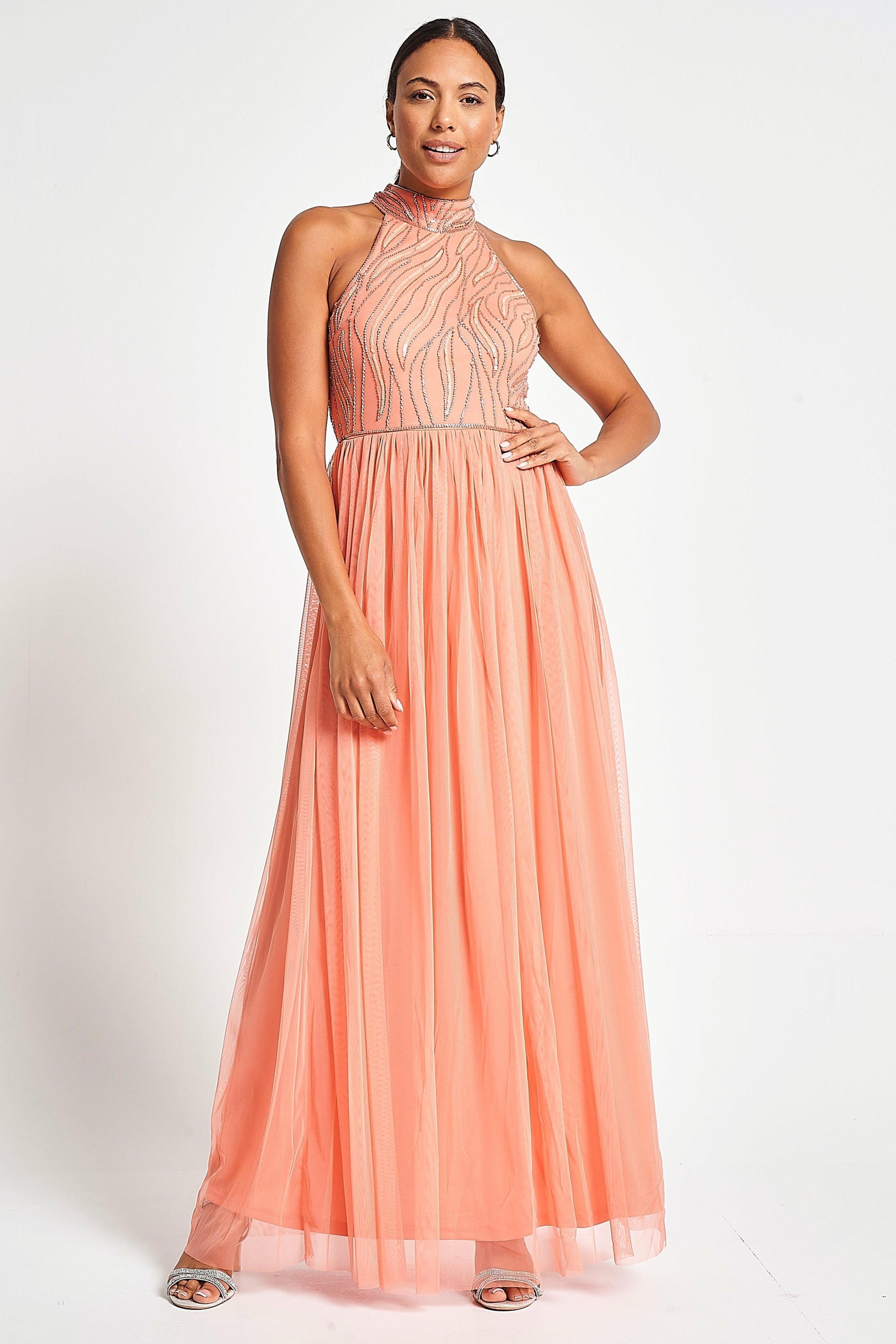 Caroline coral embellished halter neck maxi dress with intricate bead detailing and flowing full-length silhouette designed for statement occasion wear styling