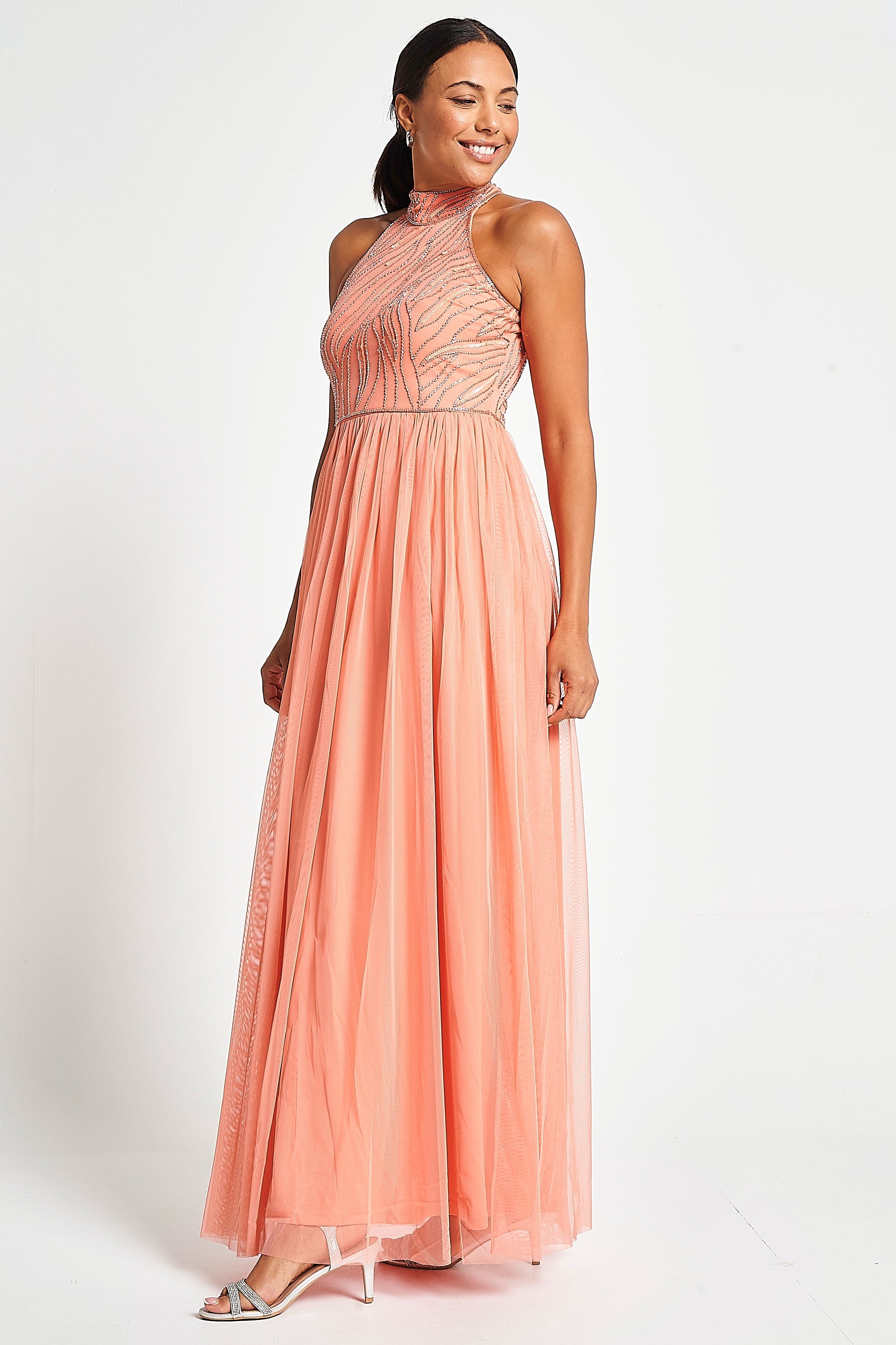 Caroline coral embellished halter neck maxi dress with intricate bead detailing and flowing full-length silhouette designed for statement occasion wear styling