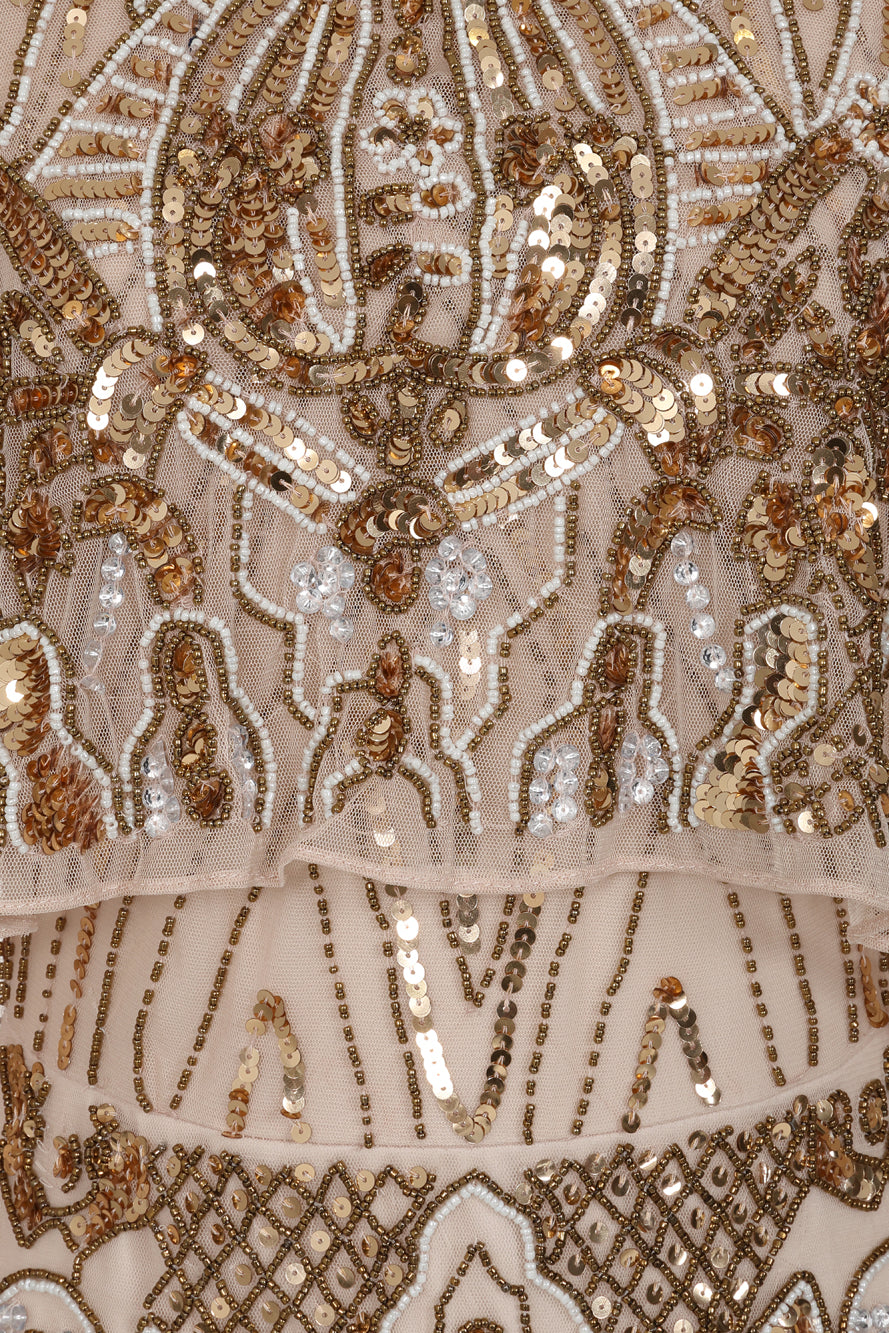 Celestine neutral-hued gold embellished maxi dress with flowing cape overlay, long sleeves, and modest elegant silhouette for weddings and formal occasions.