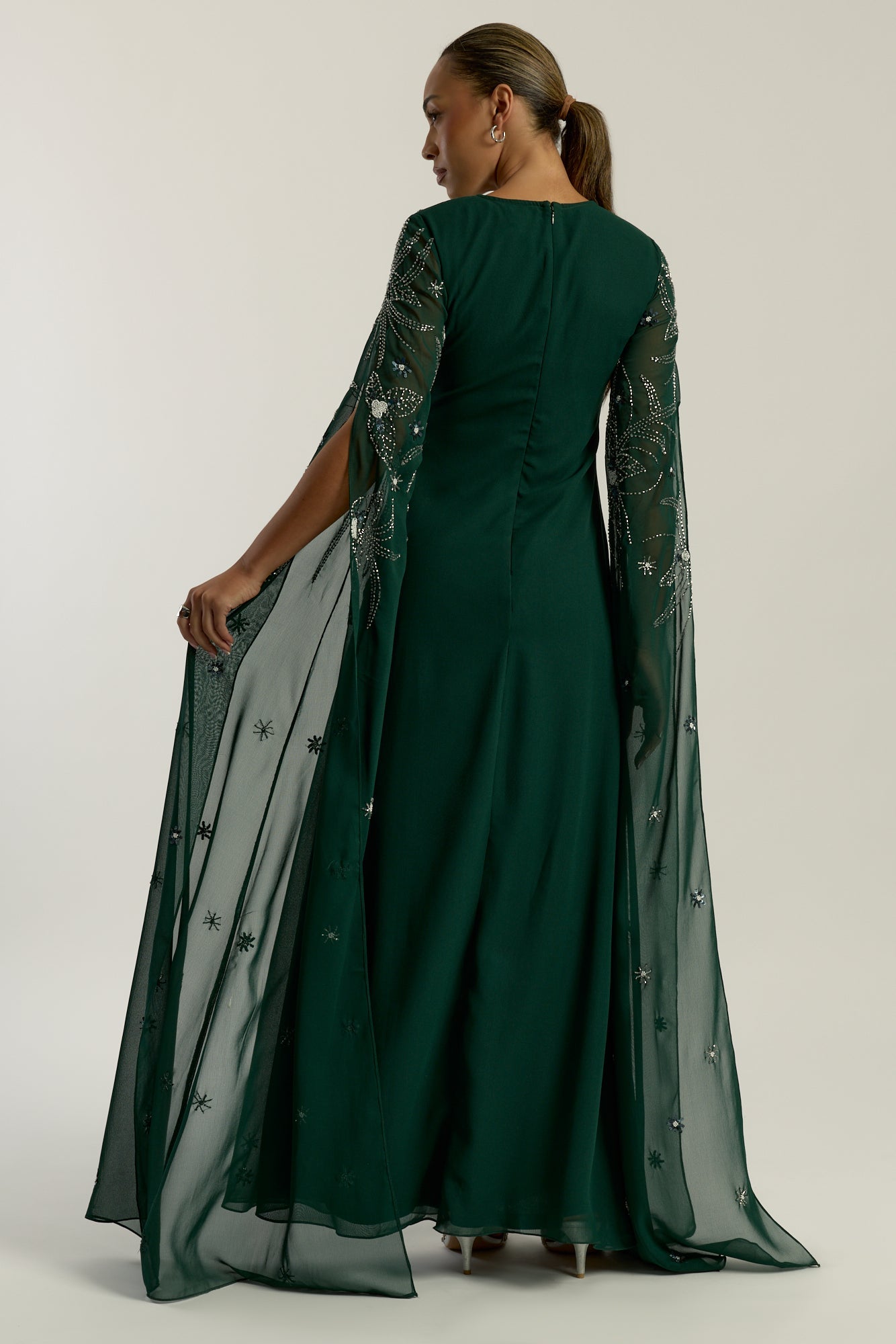 Eden green embellished cape sleeve maxi dress by Frock and Frill with delicate beadwork and a modest full-length silhouette