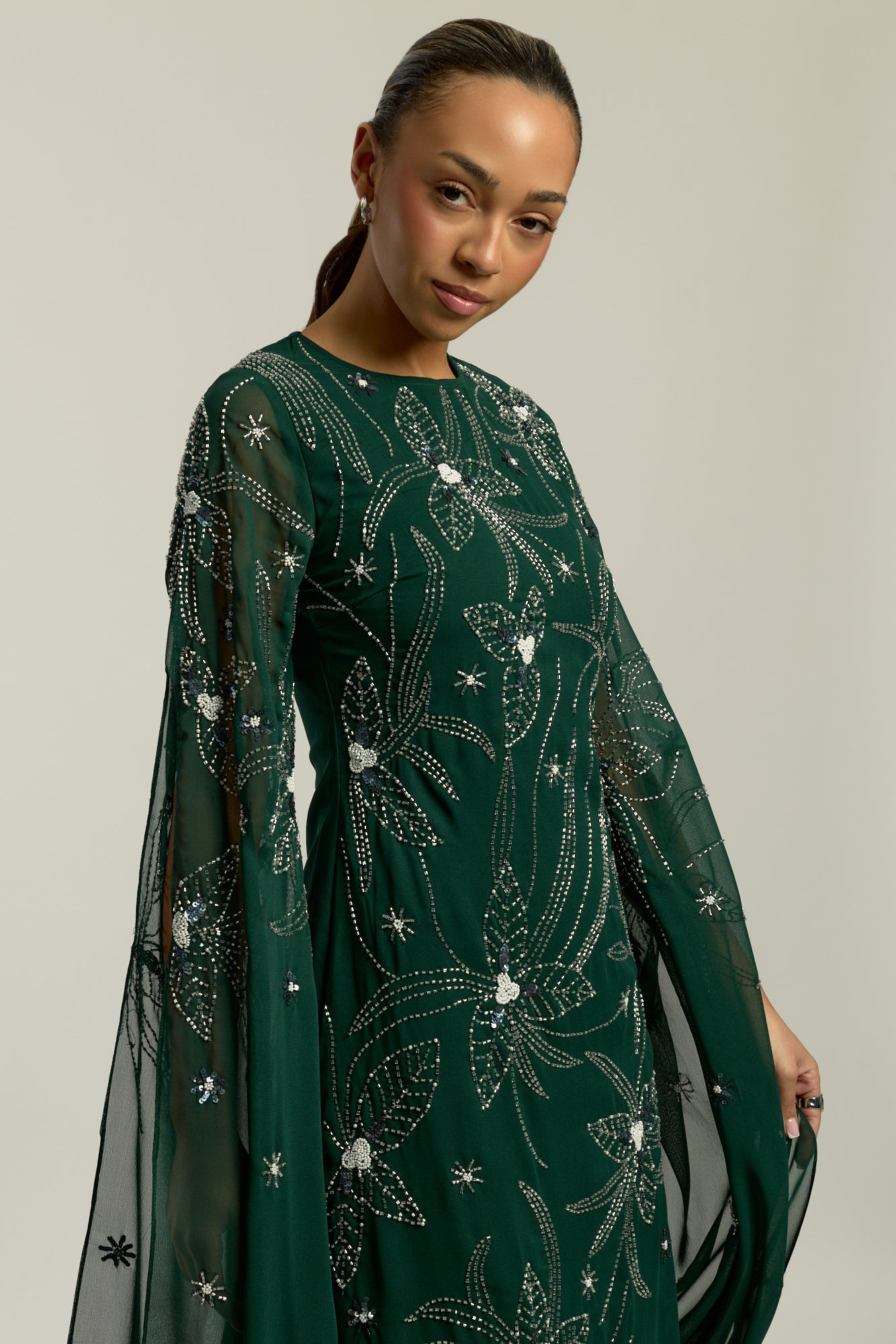 Eden green embellished cape sleeve maxi dress by Frock and Frill with delicate beadwork and a modest full-length silhouette