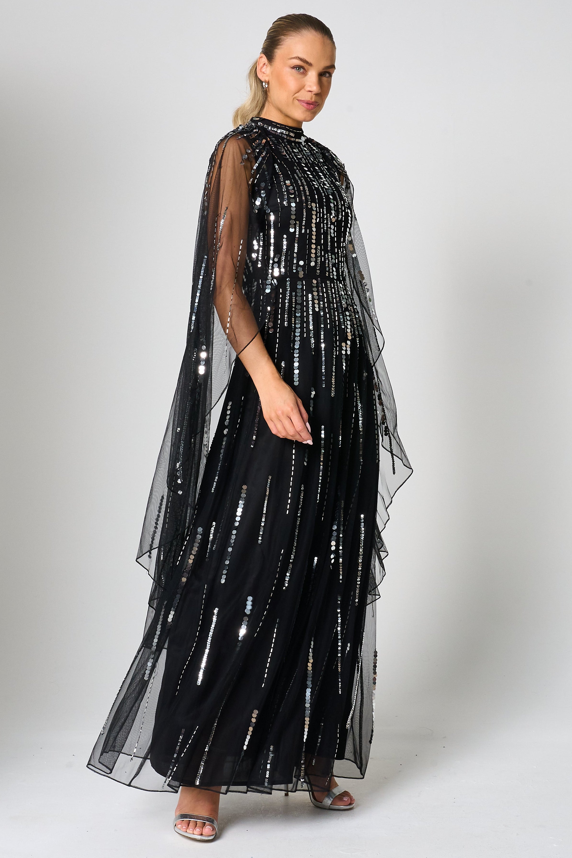 Eileen black sequin cape sleeve maxi dress with full-length silhouette and all-over sparkle designed for elegant evening and occasion wear styling