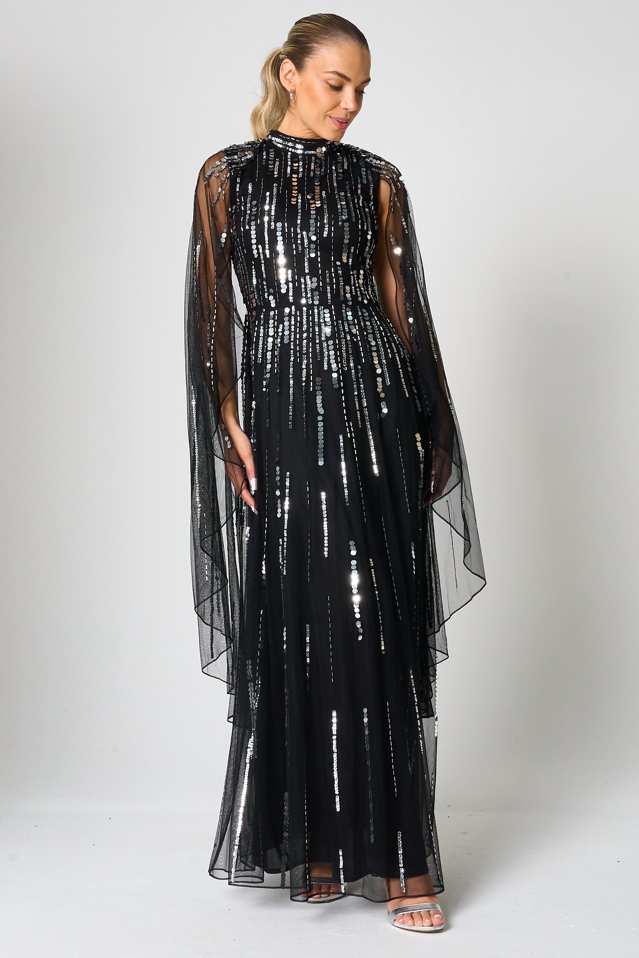 Eileen black sequin cape sleeve maxi dress with full-length silhouette and all-over sparkle designed for elegant evening and occasion wear styling