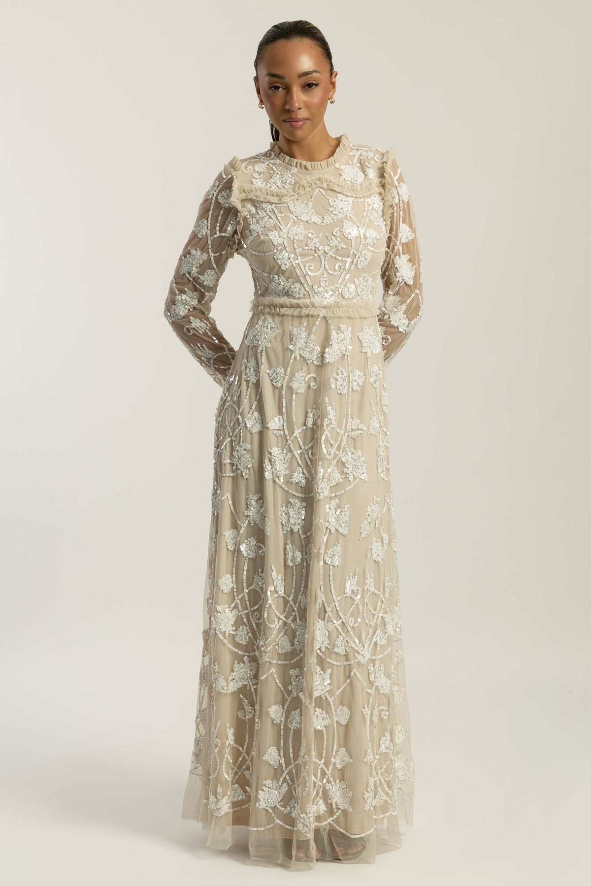 Elowen long sleeve embellished maxi dress by Frock and Frill UK in neutral tones with intricate white beadwork, modest style for weddings and formal occasions.