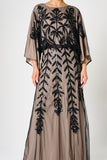Elva sequin maxi dress with black leaf motif embellishment on a neutral base, batwing sleeves and flowing silhouette for statement occasion wear styling