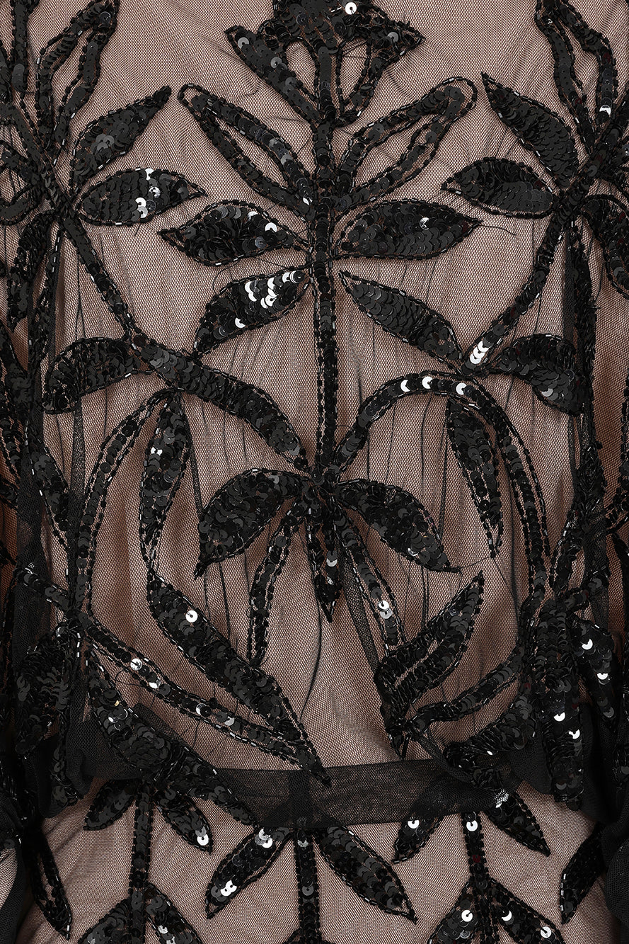 Elva sequin maxi dress with black leaf motif embellishment on a neutral base, batwing sleeves and flowing silhouette for statement occasion wear styling