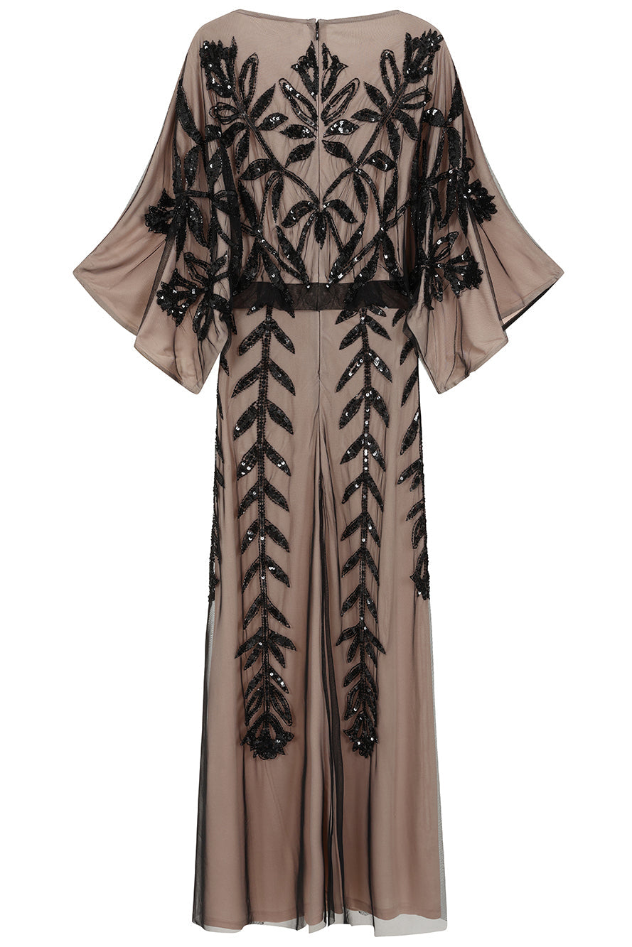 Elva sequin maxi dress with black leaf motif embellishment on a neutral base, batwing sleeves and flowing silhouette for statement occasion wear styling