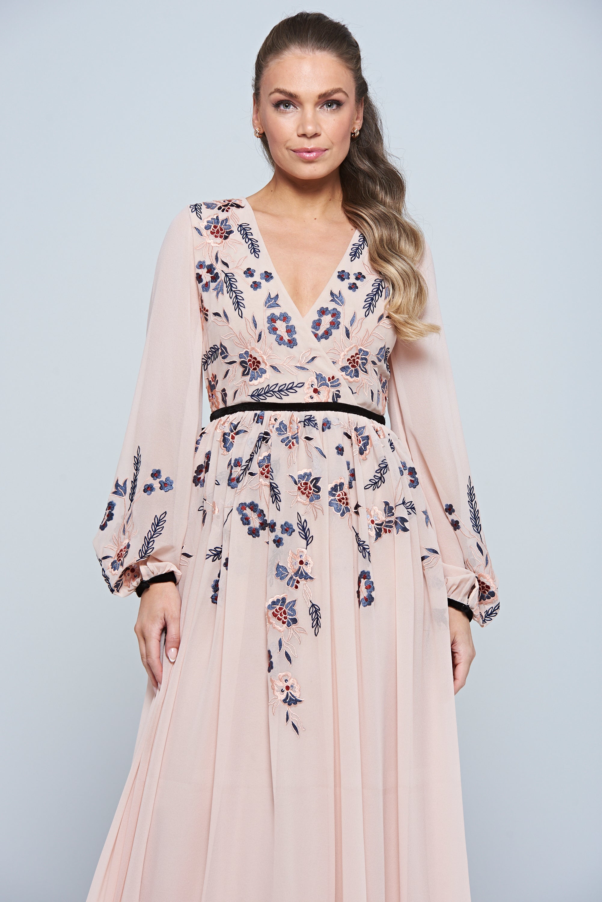 Erica Blush Floral Embroidered Maxi Dress by Frock and Frill, featuring long sleeves, V-neckline, and flowing maxi skirt in soft blush tones.