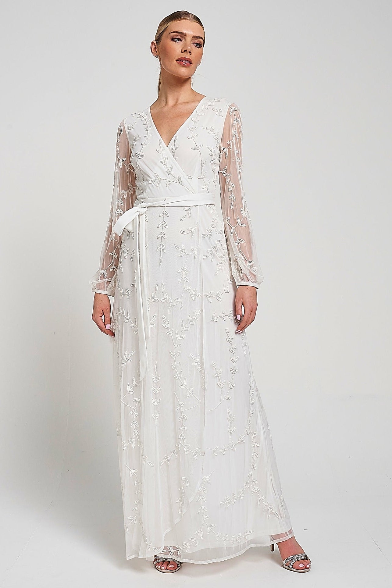 Grace white embellished maxi dress with tonal leaf detailing, faux wrap silhouette and long sleeves designed for elegant bridal and occasion wear styling