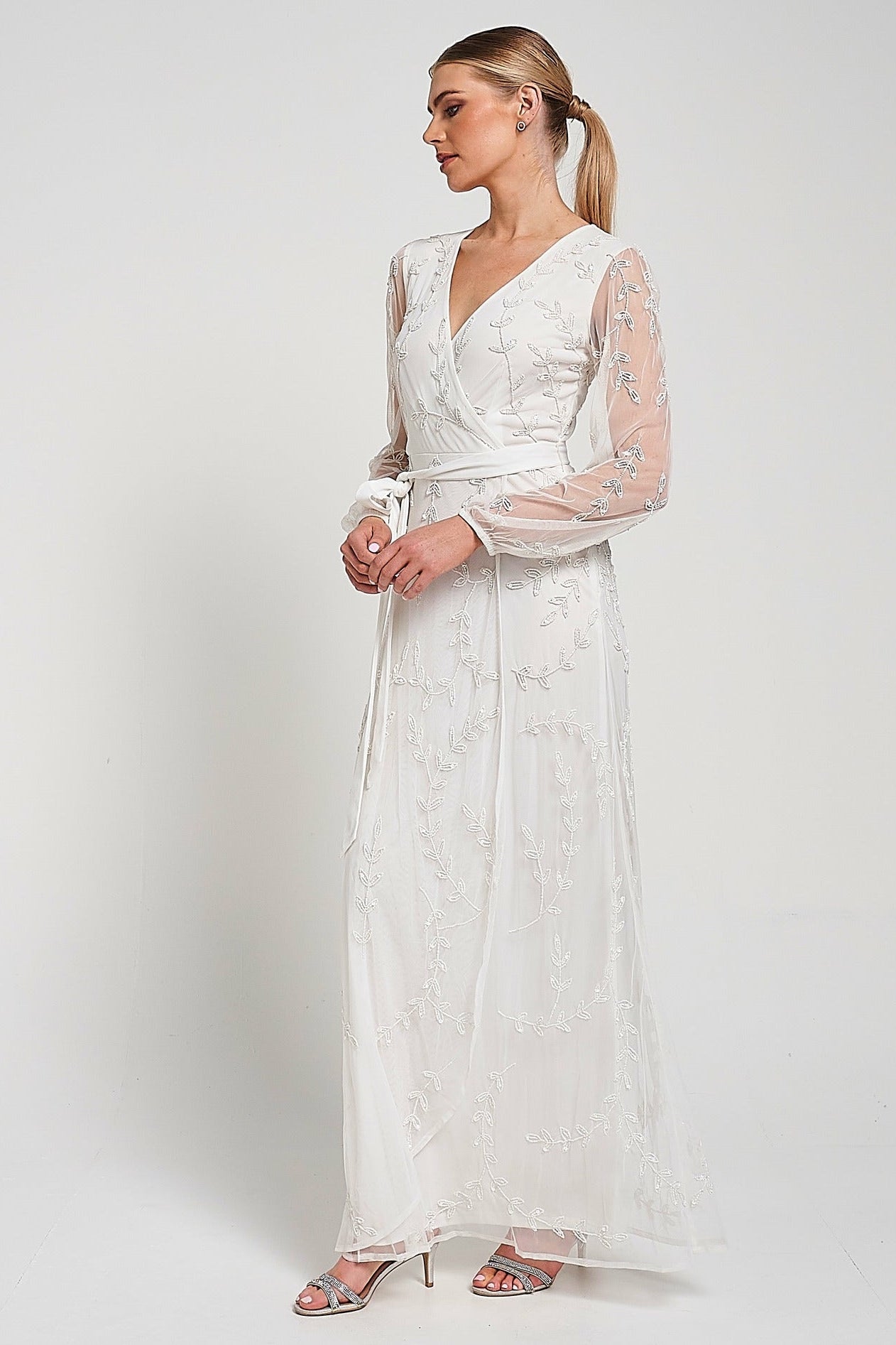 Grace white embellished maxi dress with tonal leaf detailing, faux wrap silhouette and long sleeves designed for elegant bridal and occasion wear styling