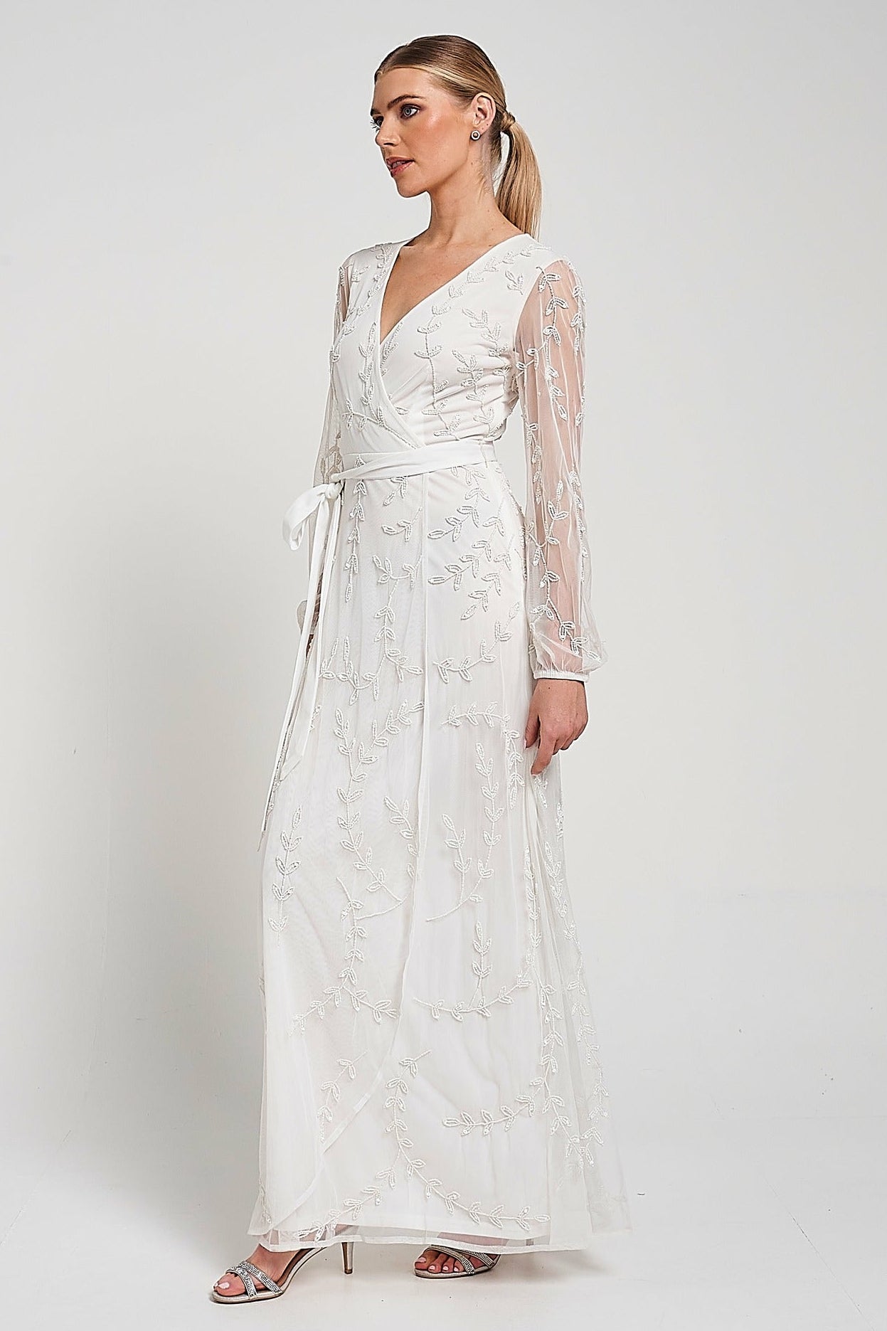 Grace white embellished maxi dress with tonal leaf detailing, faux wrap silhouette and long sleeves designed for elegant bridal and occasion wear styling