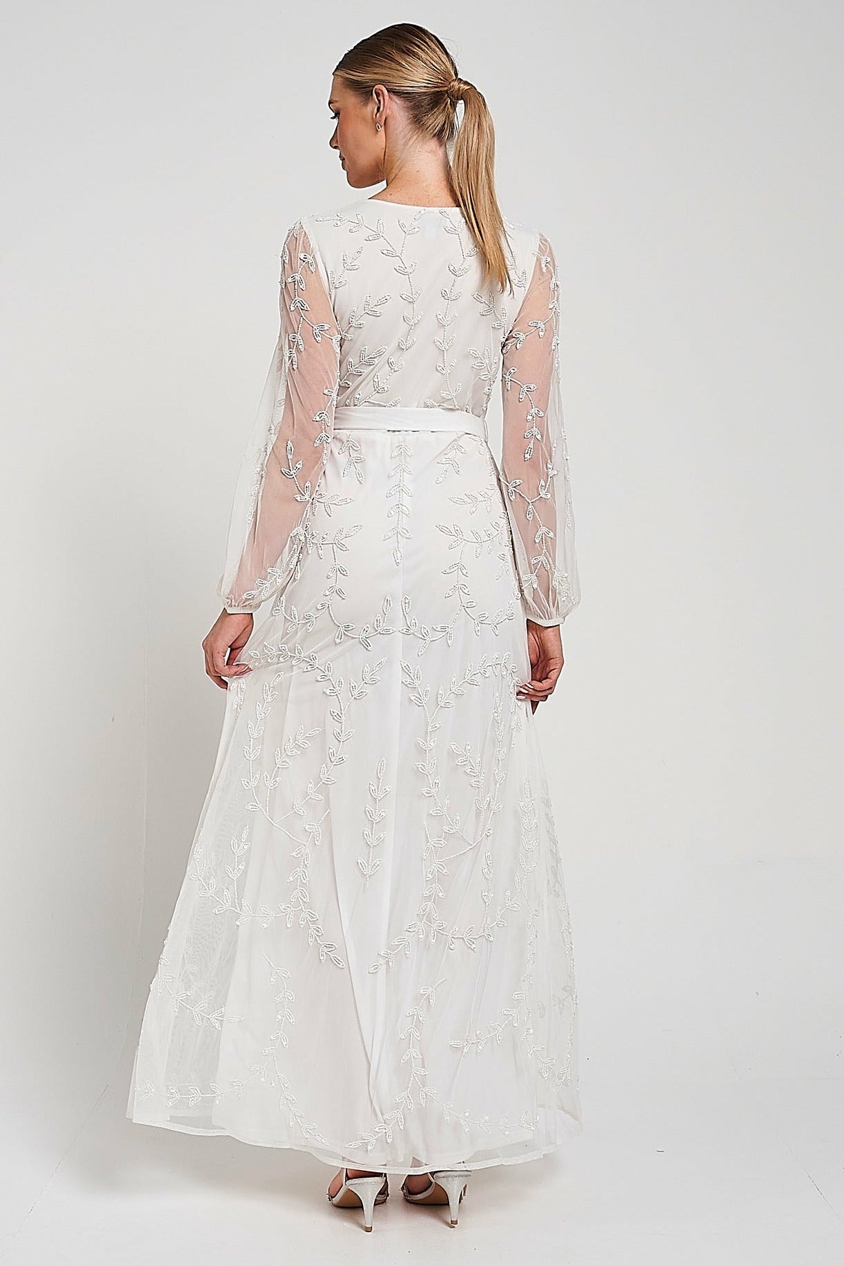 Grace white embellished maxi dress with tonal leaf detailing, faux wrap silhouette and long sleeves designed for elegant bridal and occasion wear styling
