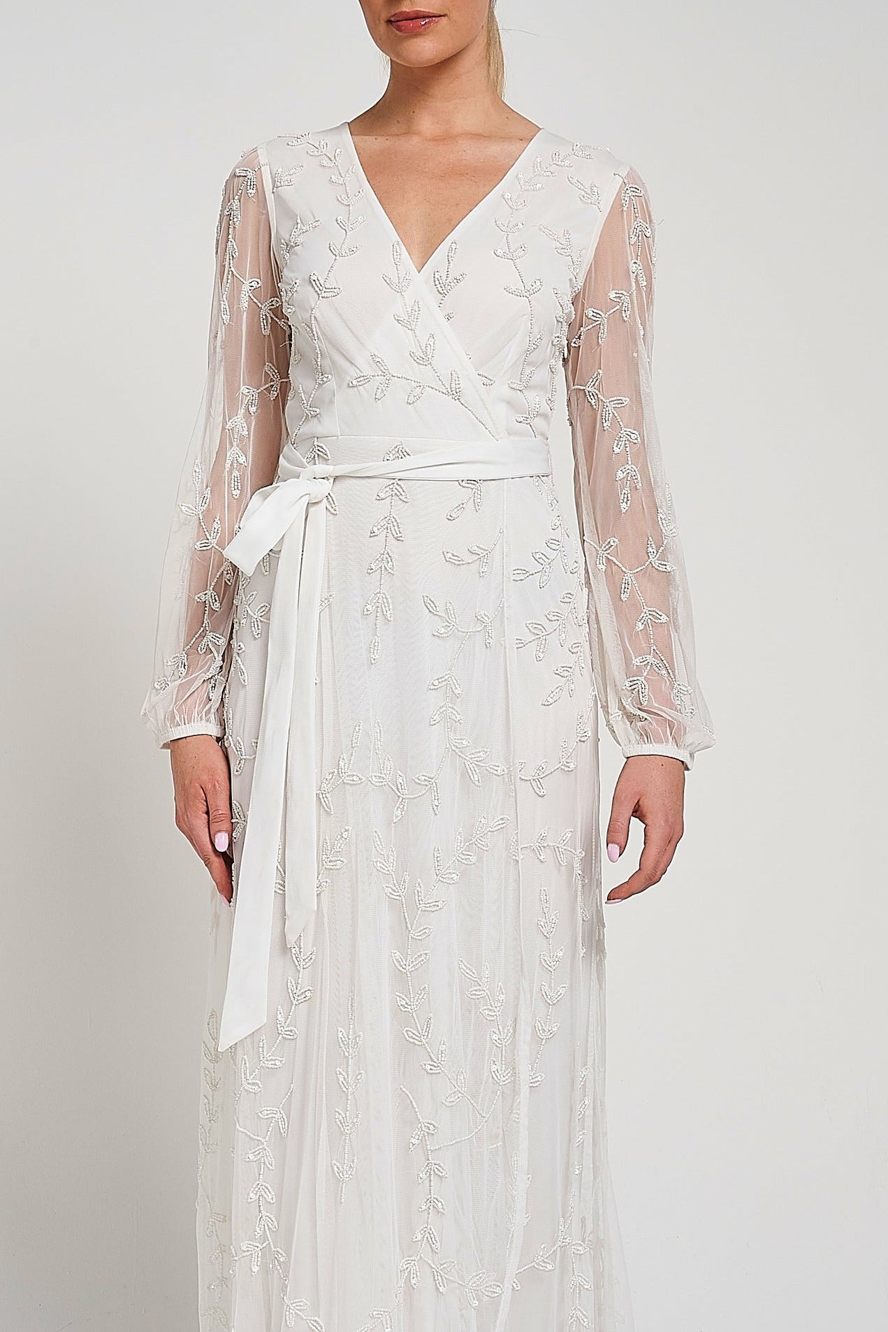 Grace white embellished maxi dress with tonal leaf detailing, faux wrap silhouette and long sleeves designed for elegant bridal and occasion wear styling
