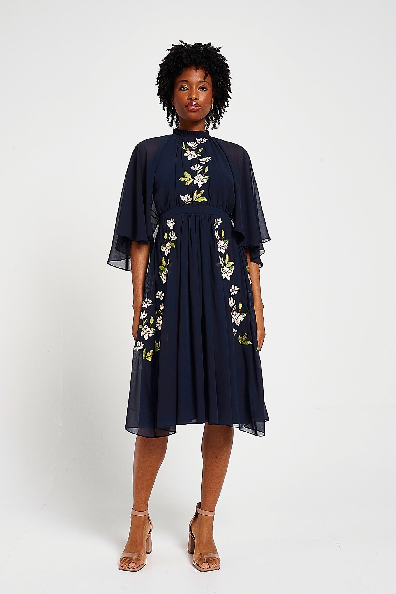 Maeve navy floral embroidered midi dress by Frock and Frill with high neckline, flowing cape sleeves, and elegant silhouette.