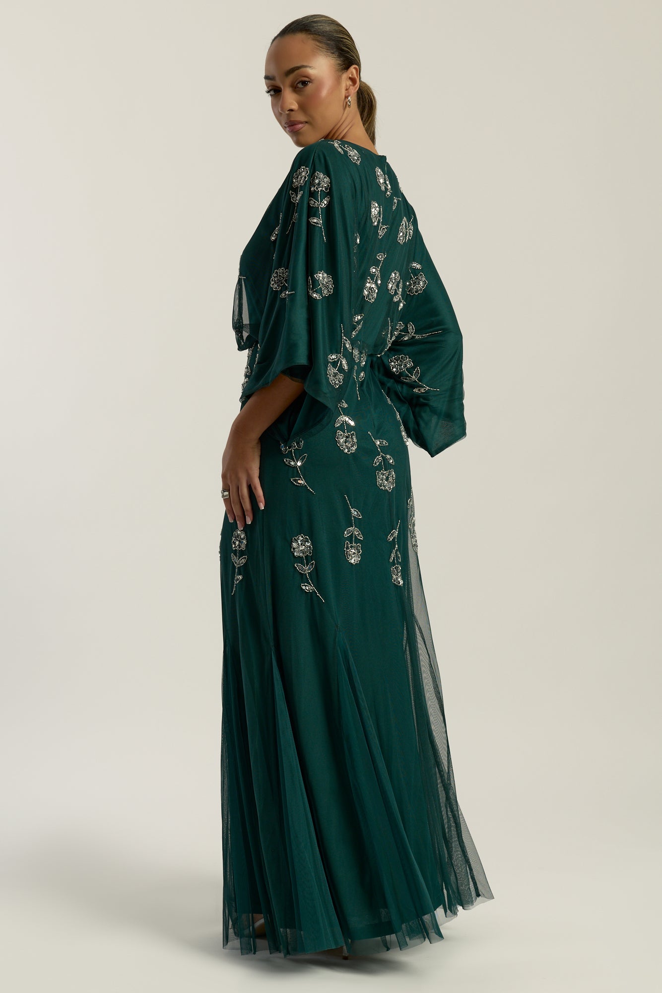 Naida rainforest green embellished maxi dress by Frock and Frill with batwing sleeves and silver floral beadwork designed for flowing statement occasion wear styling