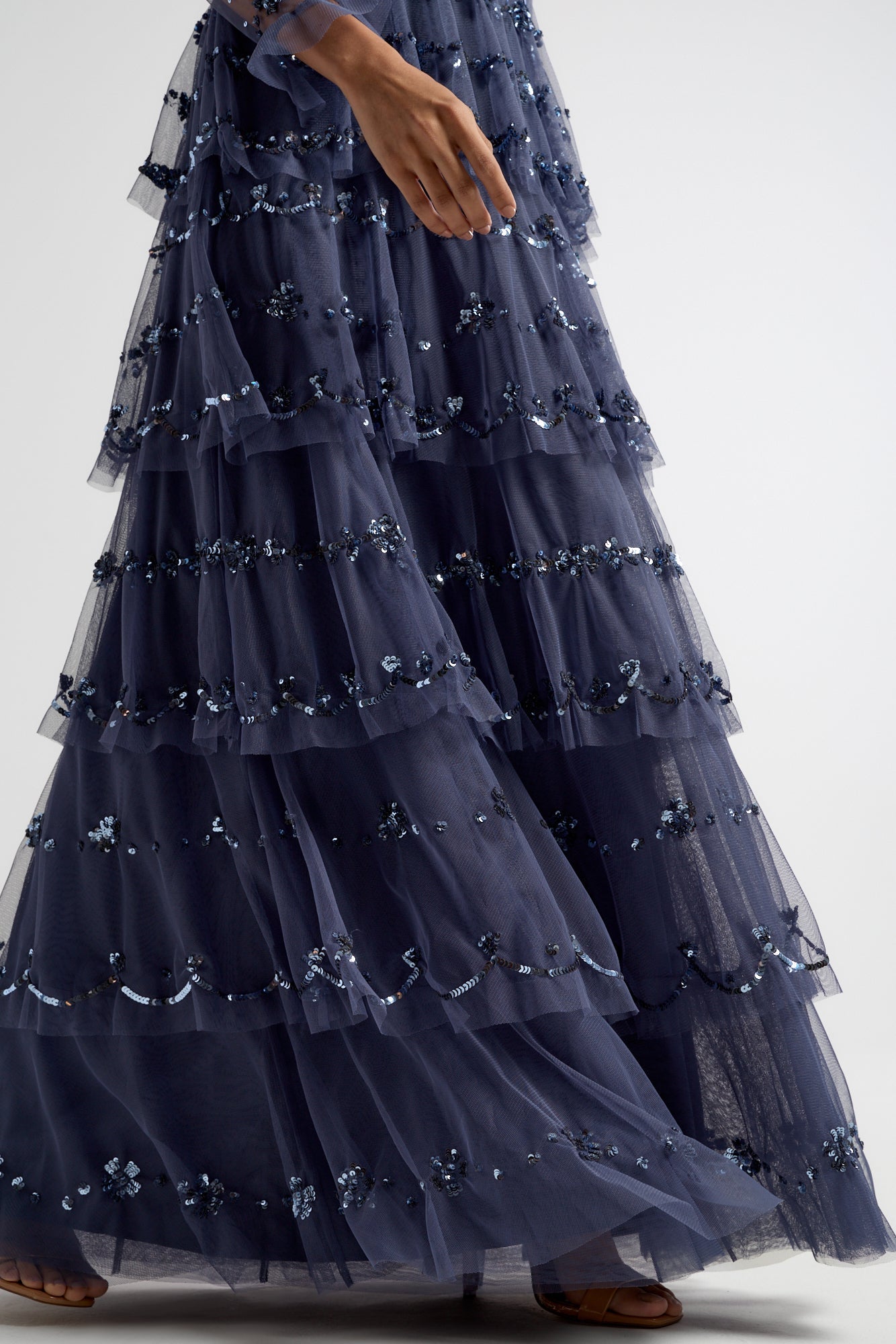 Nerissa dusty navy blue sequin tiered maxi dress with full-length sleeves, perfect for weddings, black tie balls and formal occasions. 
