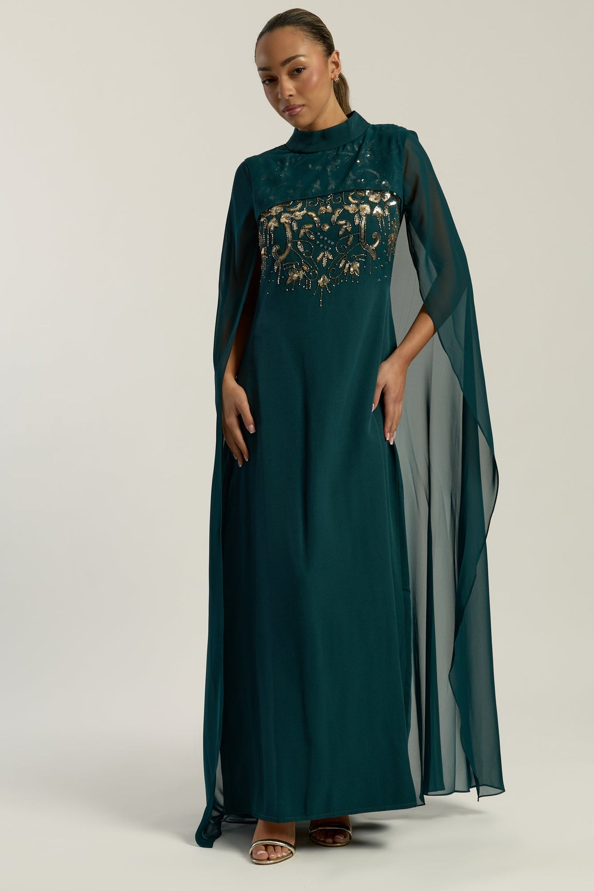 Frock and Frill Paloma Embellished Maxi Dress with cape detail, long sleeves, and flowing silhouette in rainforest green, perfect for weddings and evening events.