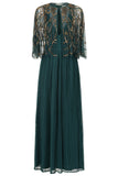 Green embellished maxi dress with flowing pleated skirt and detachable sheer cape overlay, featuring gold bead detailing and an elegant V-neck silhouette for occasion wear.